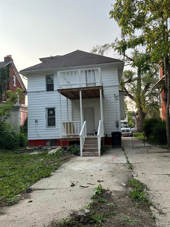 back of property featuring a balcony