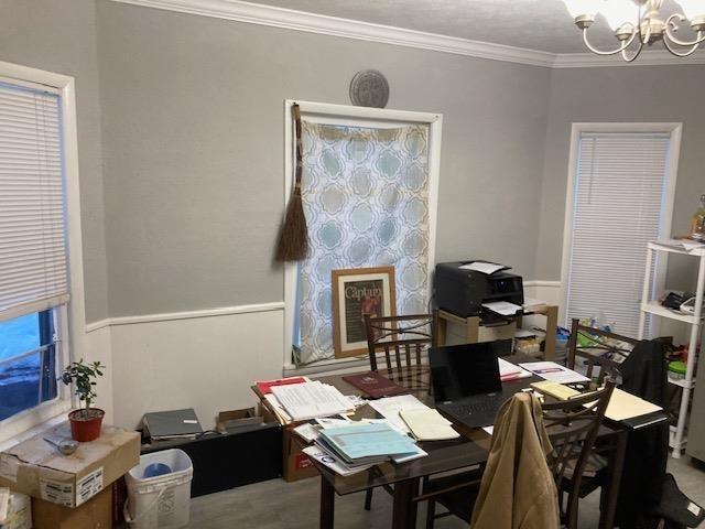 office space with crown molding and a notable chandelier