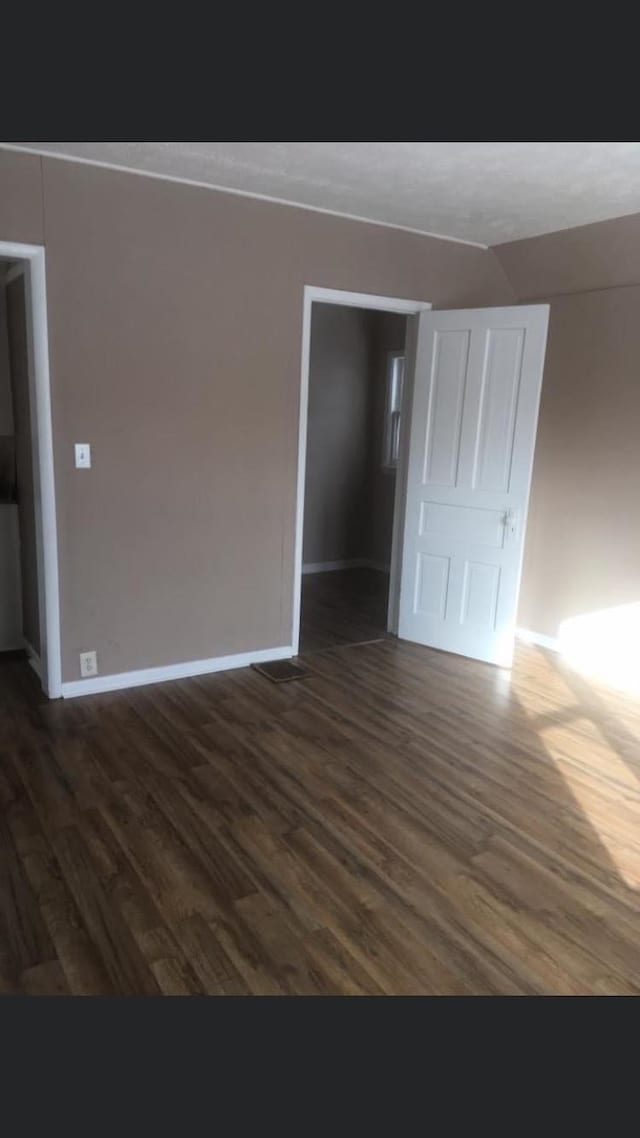 empty room featuring dark hardwood / wood-style flooring