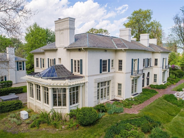 70 W Boston Blvd, Detroit, MI 48202 - rear view of property with a chimney, stucco siding, and french doors