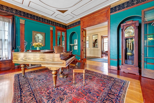 miscellaneous room with hardwood / wood-style floors and ornamental molding