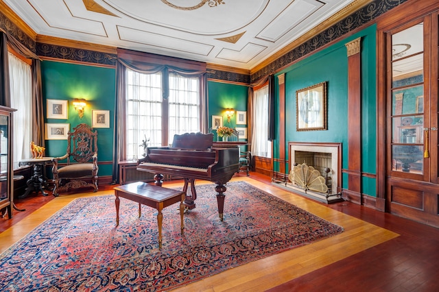 miscellaneous room with hardwood / wood-style floors, crown molding, and a high end fireplace