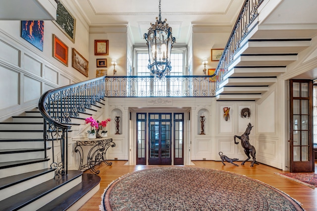 foyer featuring french doors, ornamental molding, and hardwood / wood-style floors