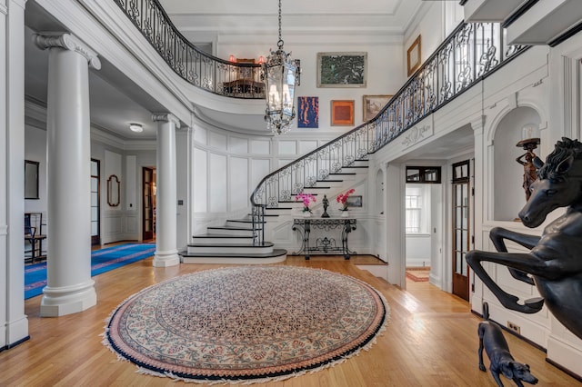 70 W Boston Blvd, Detroit, MI 48202 - entrance foyer featuring ornate columns, wood finished floors, stairway, crown molding, and a decorative wall