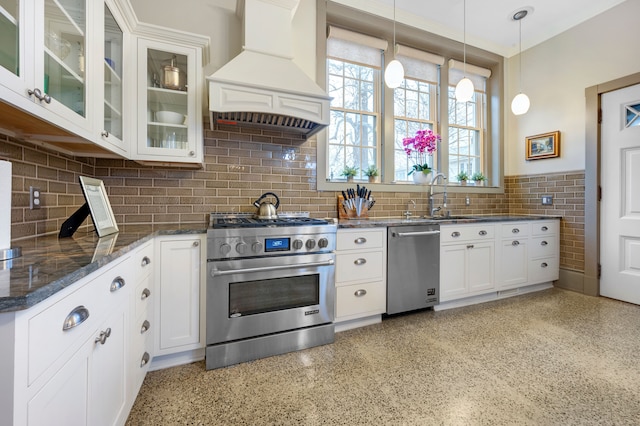 70 W Boston Blvd, Detroit, MI 48202 - kitchen with stainless steel appliances, custom exhaust hood, decorative light fixtures, dark stone counters, and white cabinets