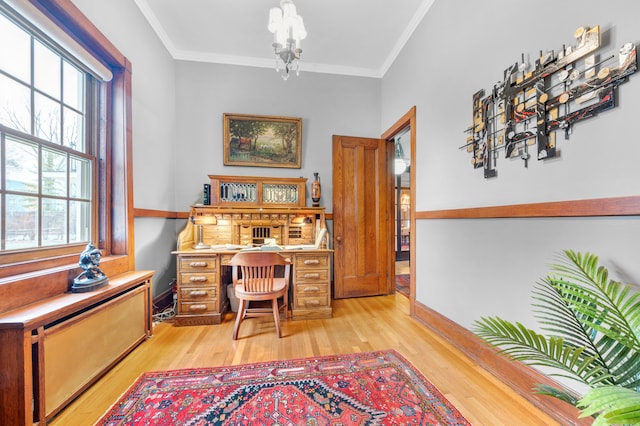 office with light wood-type flooring and ornamental molding