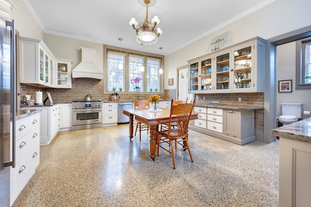 dining area featuring ornamental molding and a notable chandelier