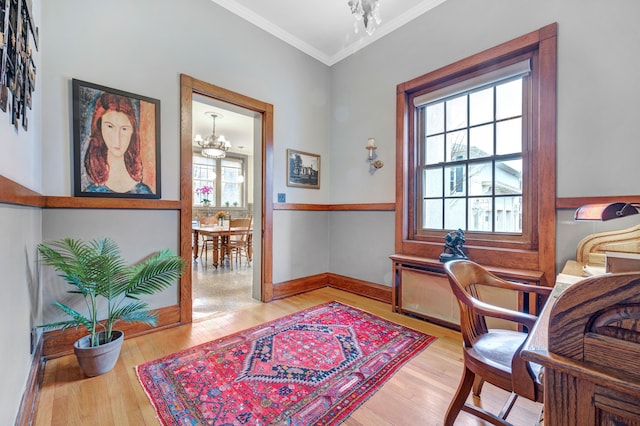 office area with hardwood / wood-style flooring, ornamental molding, and a chandelier