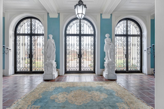 foyer entrance featuring crown molding, french doors, and beamed ceiling