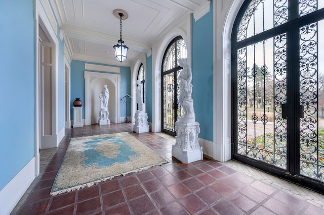 foyer featuring crown molding and french doors