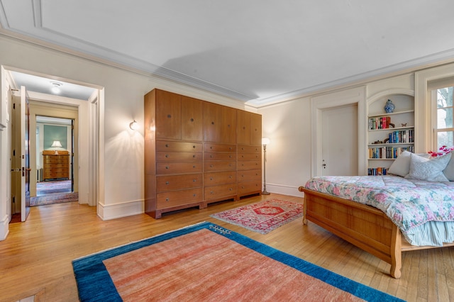 bedroom with light hardwood / wood-style floors and ornamental molding