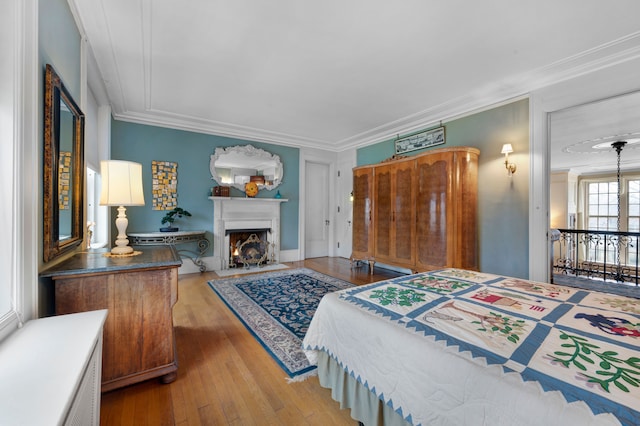 bedroom with wood-type flooring and crown molding