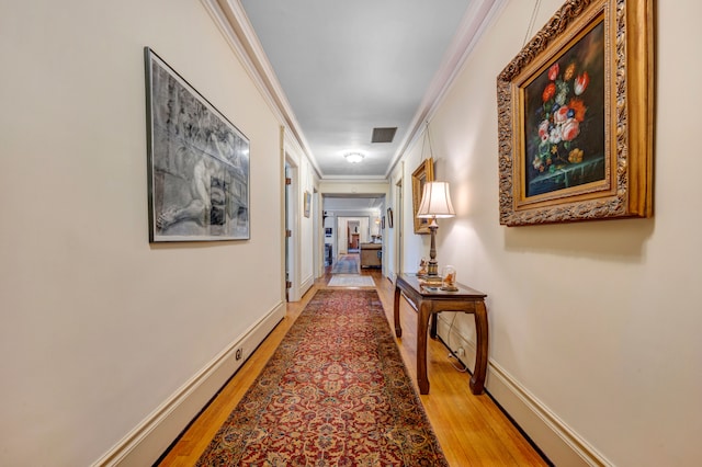 corridor featuring hardwood / wood-style floors and crown molding