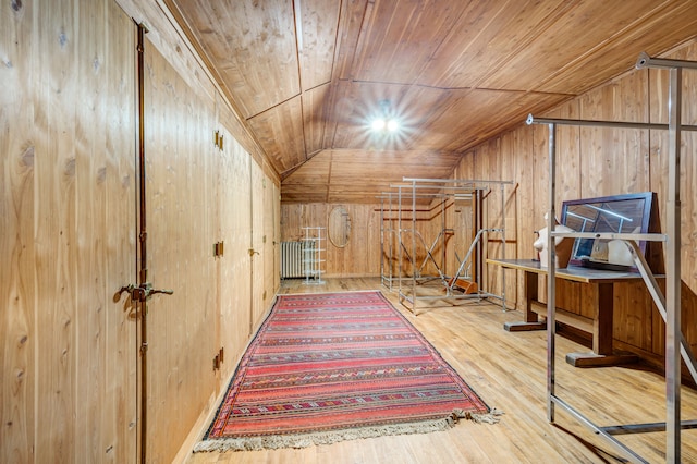 additional living space featuring wood walls, wood-type flooring, wood ceiling, and vaulted ceiling