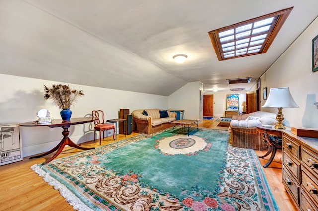 interior space with light hardwood / wood-style floors and lofted ceiling