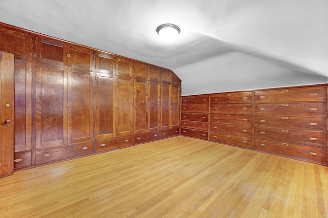 bonus room featuring vaulted ceiling and light hardwood / wood-style flooring