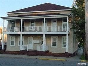 121 S Court St, Howell, MI 48843 - view of front of property with a balcony and covered porch