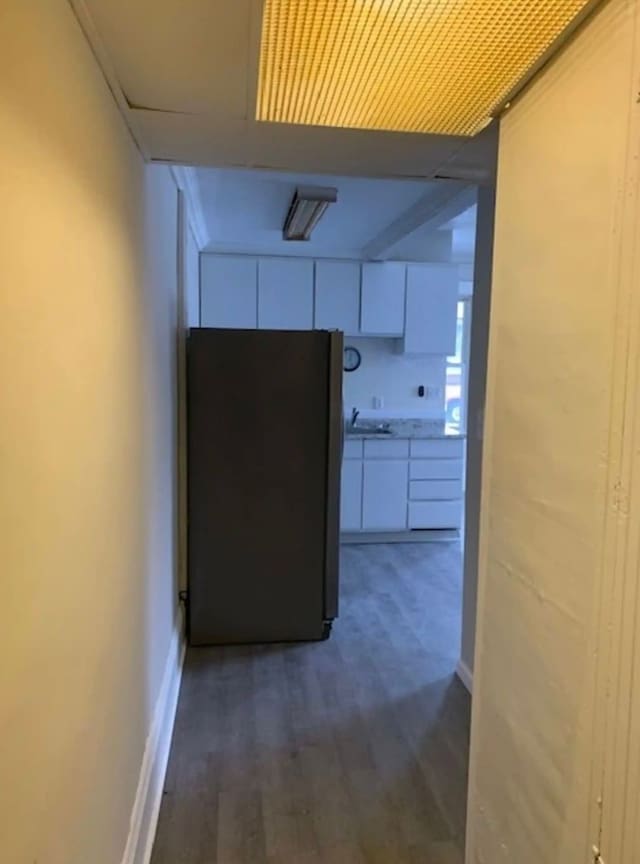 121 S Court St, Howell, MI 48843 - hallway with wood finished floors, a sink, and baseboards
