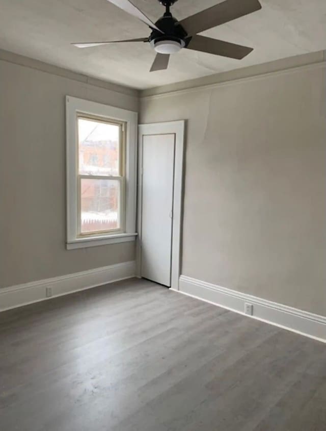 empty room with wood-type flooring and ceiling fan