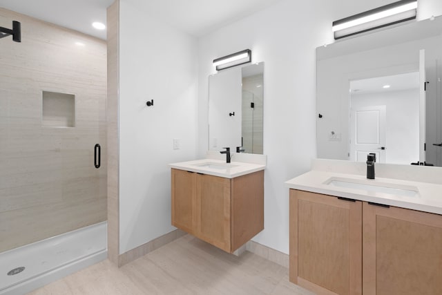 bathroom with vanity and a shower with door