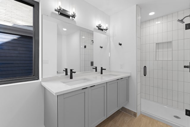 bathroom featuring vanity, an enclosed shower, and hardwood / wood-style flooring