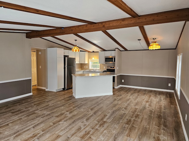 kitchen with stainless steel appliances, pendant lighting, lofted ceiling with beams, wood-type flooring, and white cabinetry