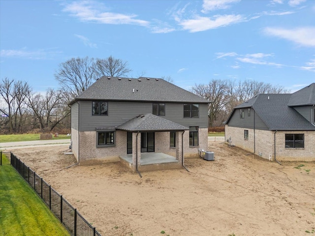 rear view of property featuring central air condition unit and a patio area