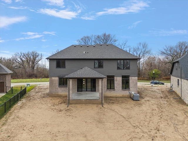 back of property with central AC and a patio area