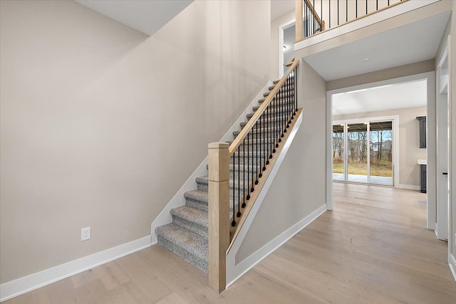 stairs featuring hardwood / wood-style flooring