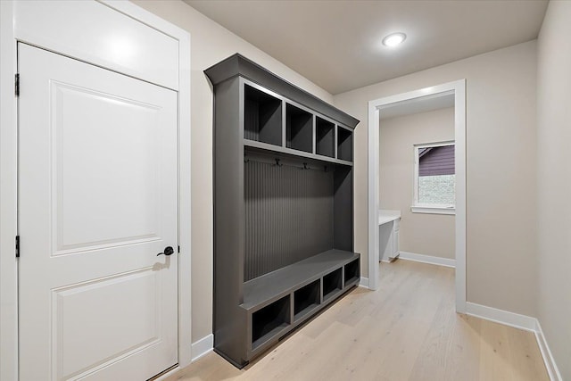 mudroom with light hardwood / wood-style floors