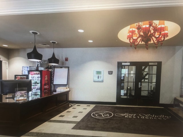 welcome area with french doors and an inviting chandelier