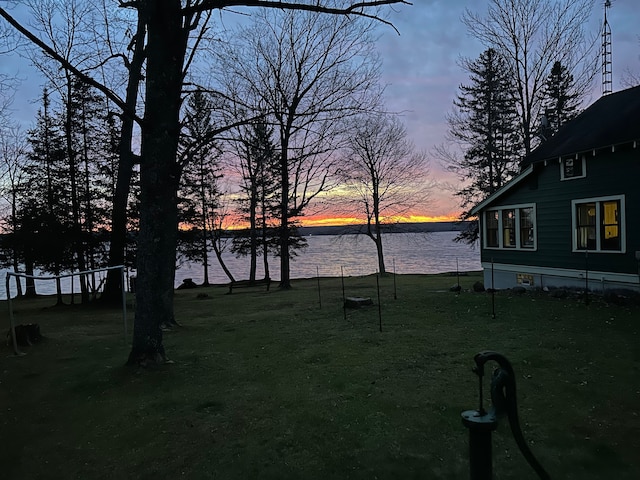 yard at dusk with a water view