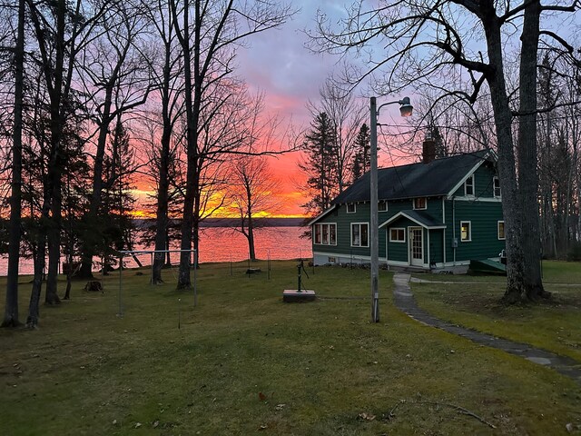 9516 State Highway M64, Marenisco, MI 49947 - yard at dusk featuring a lawn and a water view