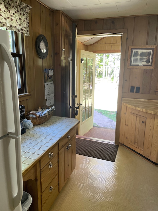 doorway to outside featuring wooden walls