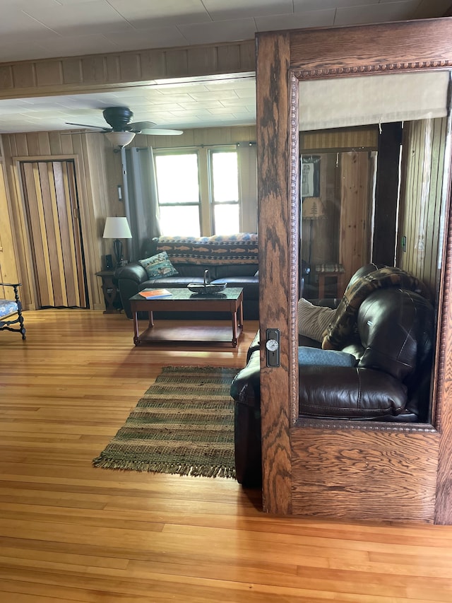 living room featuring hardwood / wood-style floors and ceiling fan