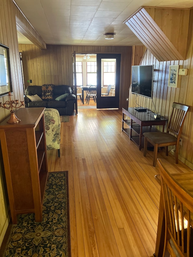 living room with wooden walls and light wood-type flooring