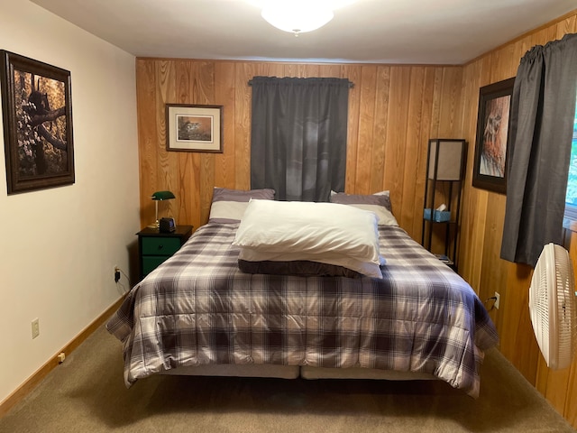 carpeted bedroom with wooden walls