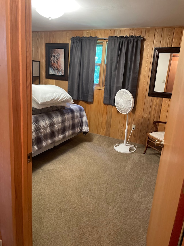 bedroom featuring carpet and wooden walls