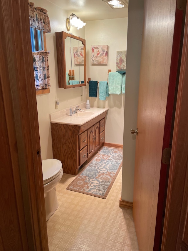 9516 State Highway M64, Marenisco, MI 49947 - bathroom with tile patterned floors, vanity, toilet, and baseboards