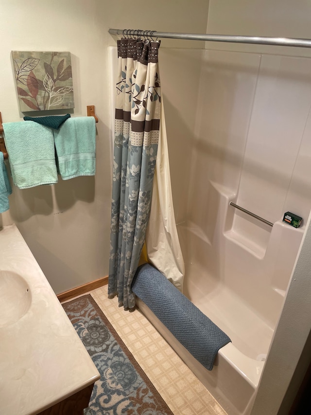 bathroom featuring vanity and shower / bathtub combination with curtain