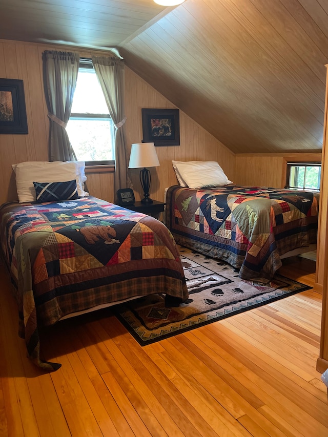 bedroom featuring wood-type flooring, wood walls, lofted ceiling, and wood ceiling