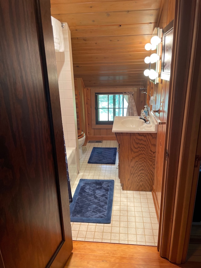 bathroom with tile patterned flooring, vanity, toilet, and wood ceiling