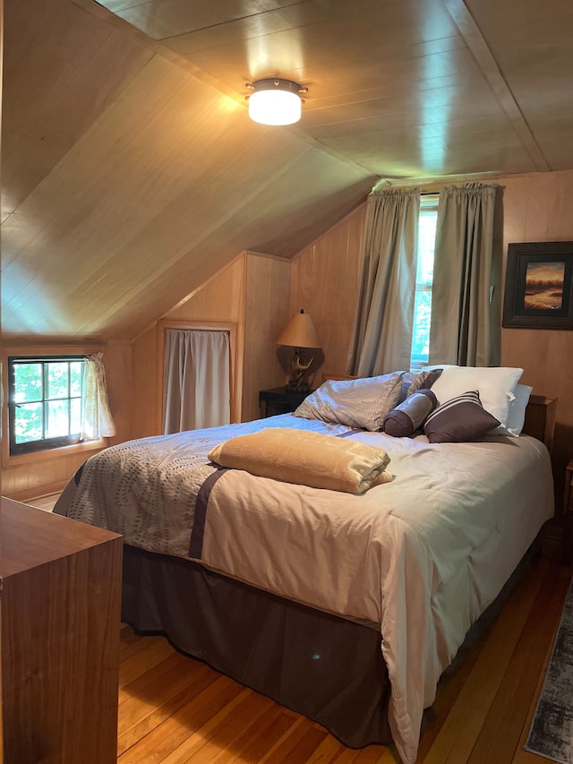 bedroom featuring hardwood / wood-style floors and lofted ceiling