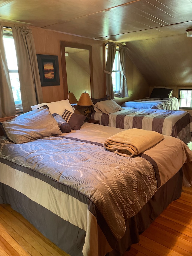 bedroom featuring wood-type flooring and lofted ceiling