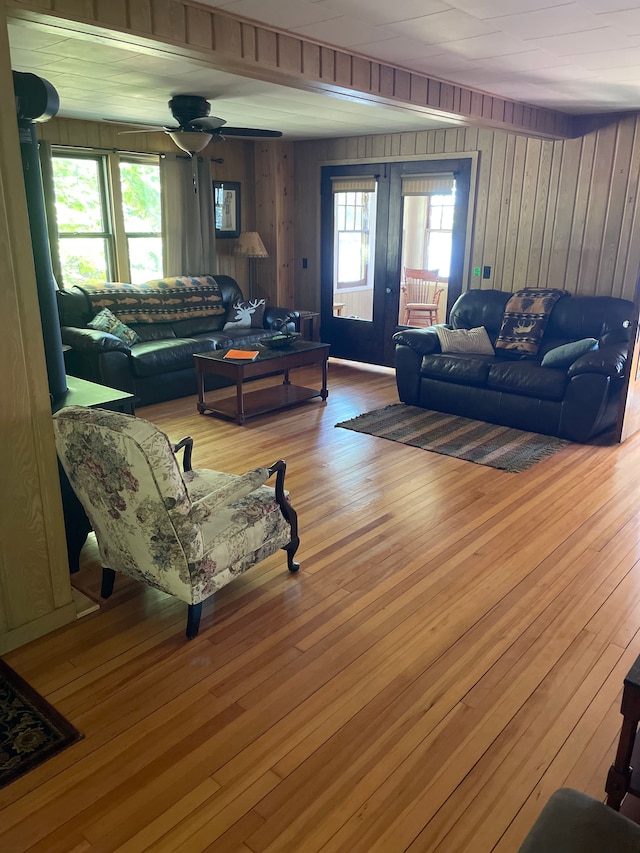 9516 State Highway M64, Marenisco, MI 49947 - living room featuring wood walls, wood finished floors, and a ceiling fan