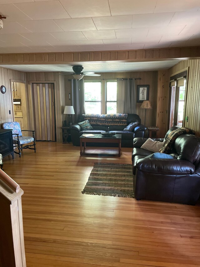 9516 State Highway M64, Marenisco, MI 49947 - living area featuring wooden walls, plenty of natural light, and wood finished floors