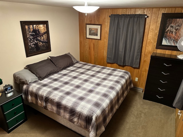 carpeted bedroom featuring wood walls