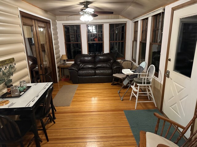 living room with wood-type flooring, ceiling fan, and lofted ceiling