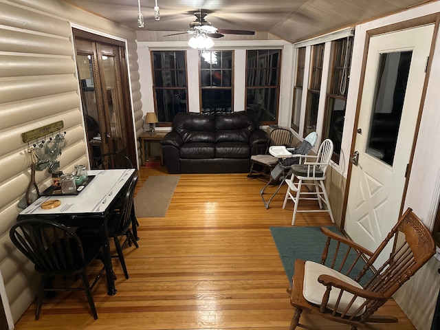 sunroom with ceiling fan and vaulted ceiling