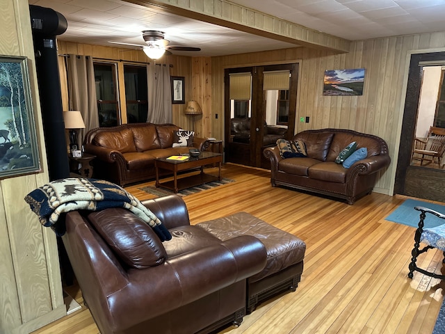 9516 State Highway M64, Marenisco, MI 49947 - living area with wood walls, a ceiling fan, and wood-type flooring